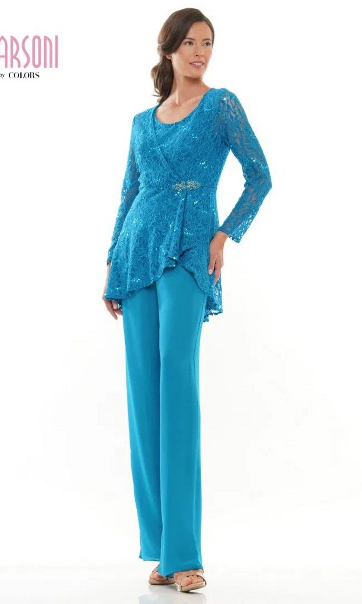 A woman in a Caribbean Blue Marsoni M305 Long Formal Pantsuit with lace jacket and wide-leg chiffon pants stands against a plain white background, wearing beige sandals.